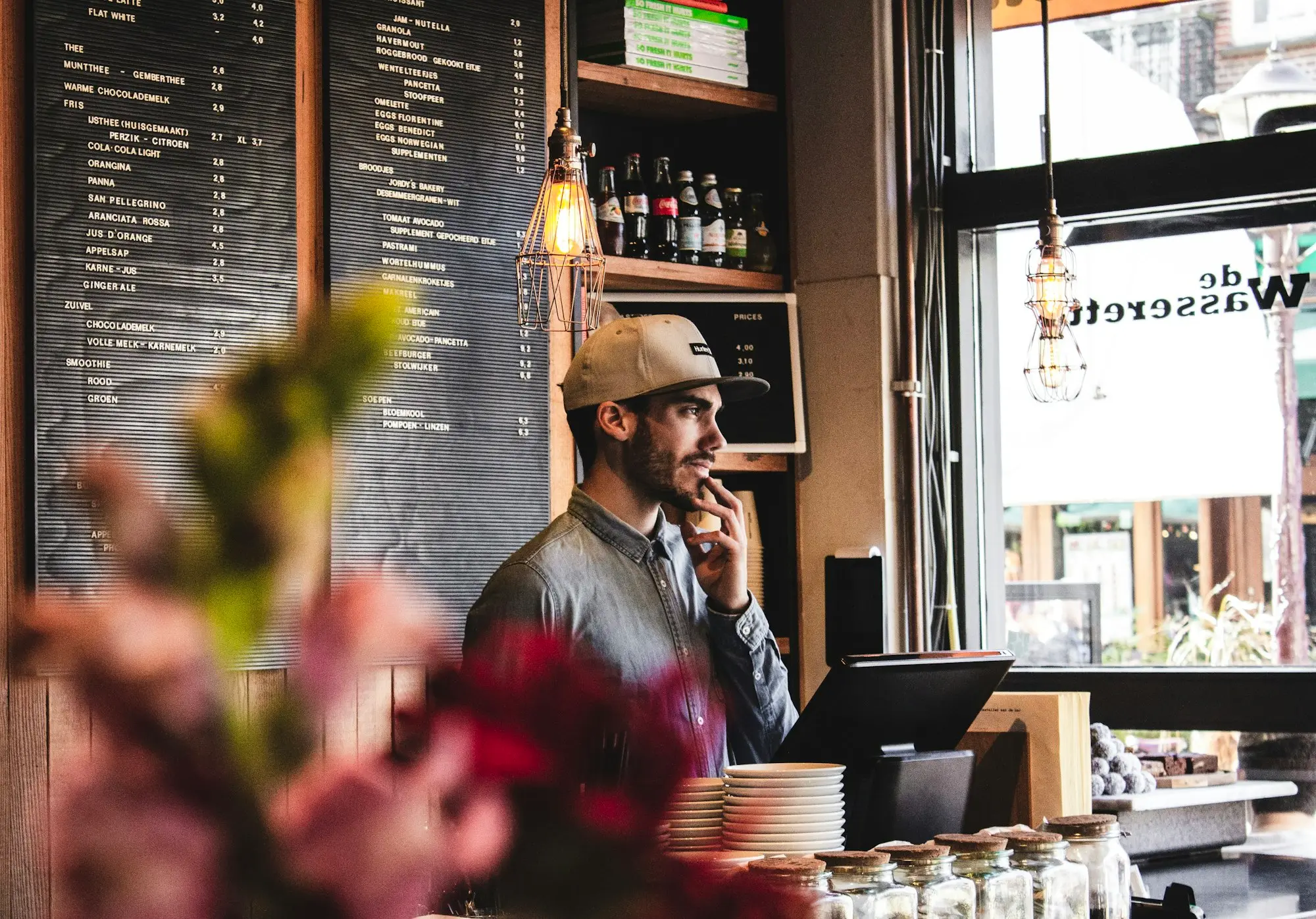 Café owner on a phone call behind the counter