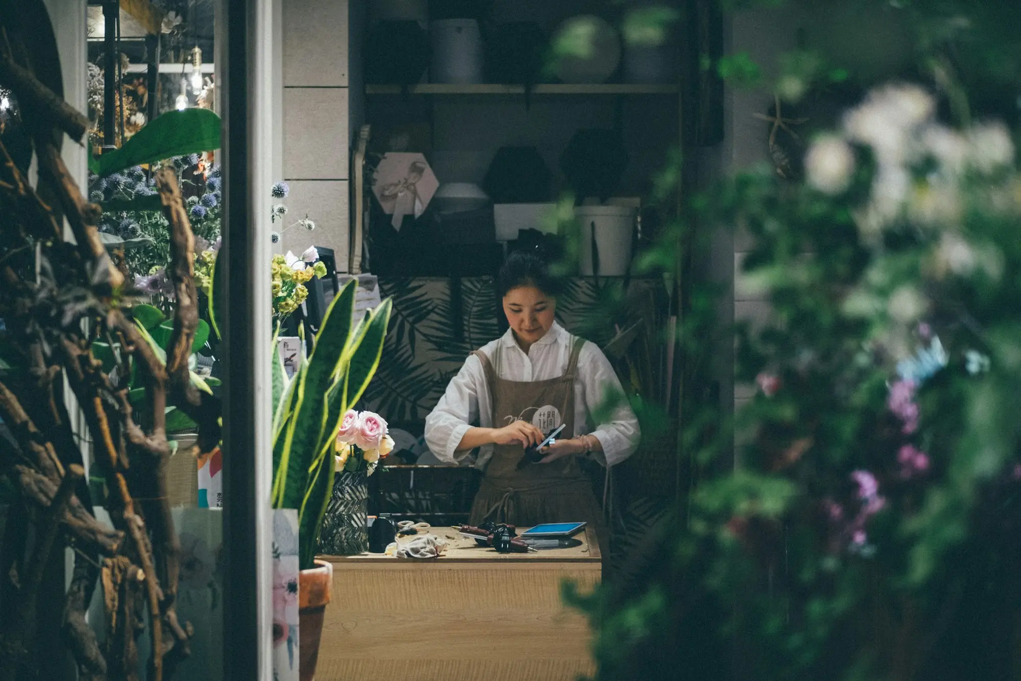 Florist working at the counter of a small flower shop