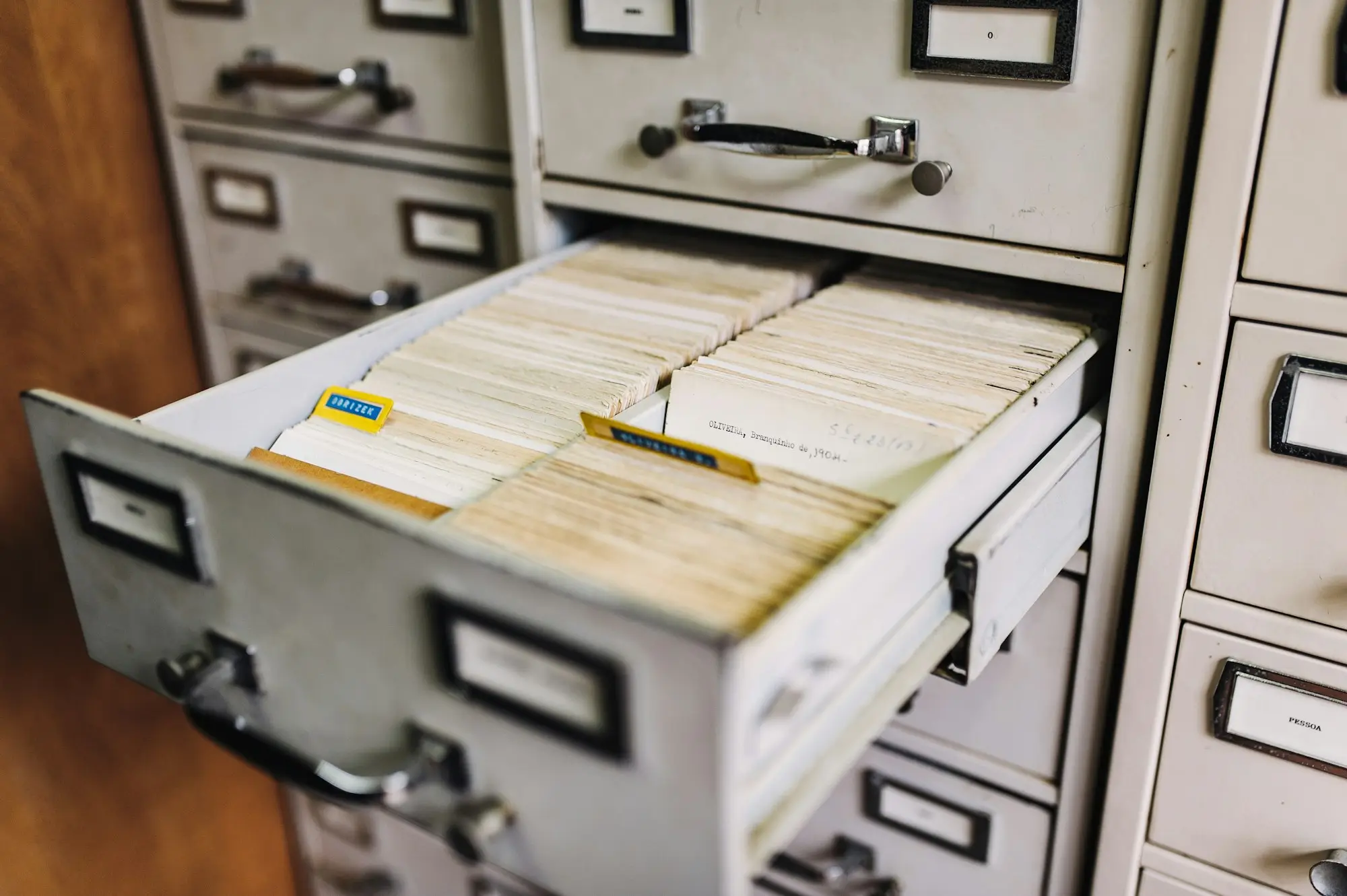Open filing cabinet drawer full of neatly labelled folders